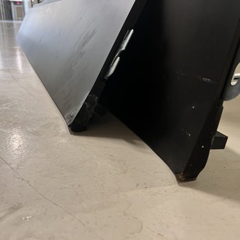CubeSmart Self Storage - The image shows a black and silver metal object, likely a sign or display stand, resting on a beige tiled floor. The object has a black base with visible scratches and a silver panel attached at an angle. The setting appears to be indoors, possibly in a commercial or public space, with a background that includes some metallic fixtures and a corridor. - Self Storage Near Me - Chandler, Arizona