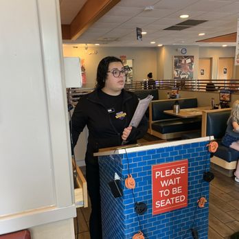 IHOP - a woman standing at a counter in a restaurant - American Near Me - Ashburn, Virginia