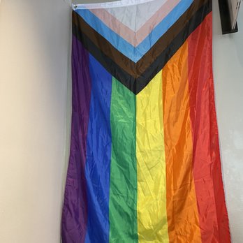 Starbucks - a rainbow flag hanging on a wall - Coffee & Tea Near Me - Portland, Oregon