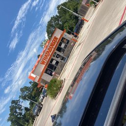 a car parked in front of a gas station