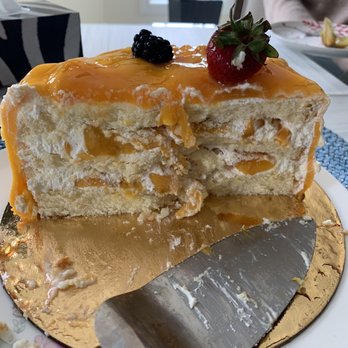 St Germain Bakery - Fresh mango cake cross section after we devoured half of it. They really load up on the mango! - Bakeries Near Me - Toronto, Ontario St Germain Bakery - Fresh mango cake cross section after we devoured half of it. They really load up on the mango! - Bakeries Near Me - Toronto, Ontario