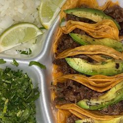 Restaurant El Charro - Mini asada tacos with avocado onion cilantro and limes.