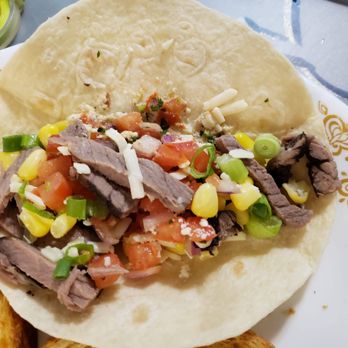 Freshii - a taco with meat and vegetables on a plate - Salad Near Me - Vancouver, British Columbia Freshii - a taco with meat and vegetables on a plate - Salad Near Me - Vancouver, British Columbia