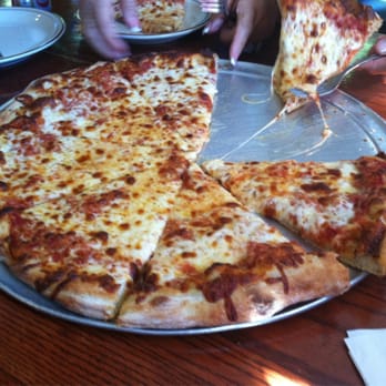 Fresolone's Pizza Pasta & Sub - a pizza being sliced - Pizza Near Me - Lincoln, New Hampshire Fresolone's Pizza Pasta & Sub - a pizza being sliced - Pizza Near Me - Lincoln, New Hampshire
