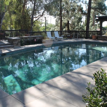 Bayrich Construction - a pool with a deck and lounge chairs - General Contractors Near Me - Anaheim, California