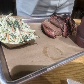 NEVS Barbecue - Brisket with Cole slaw. It's a different kind of Cole slaw, it has a really good flavor to it. I like how it was different. - Barbeque Near Me - Palm Beach Gardens, Florida