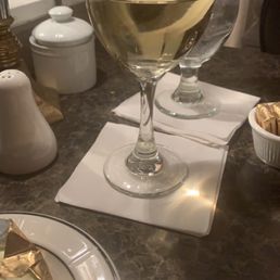 a glass of wine and a plate of food a glass of wine and a plate of food