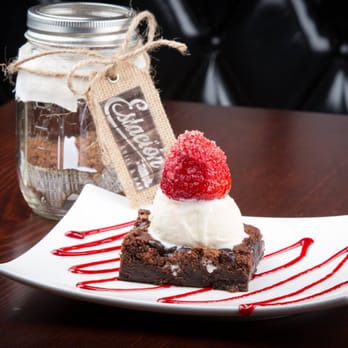 Estacion Grill & Bar - a chocolate brownie topped with whipped cream and raspberries - Latin American Near Me - Astoria, New York Estacion Grill & Bar - a chocolate brownie topped with whipped cream and raspberries - Latin American Near Me - Astoria, New York