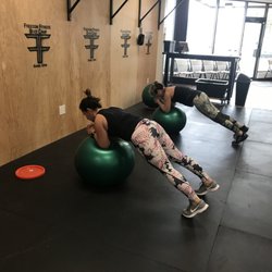 Freedom Fitness Boot Camp - Members focusing on their form while balancing.