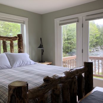 Trout River Lodge - Master bedroom with views of Trout River - Hotels Near Me - Montgomery, Vermont