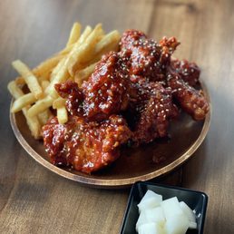 Half chicken in spicy sauce, fries and pickled daikon radish Half chicken in spicy sauce, fries and pickled daikon radish