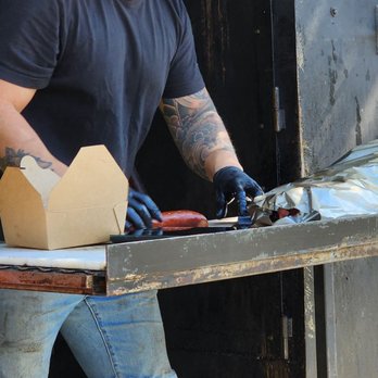 Texas Smoke BBQ - a man working on a grill - Food Trucks Near Me - Langley, British Columbia Texas Smoke BBQ - a man working on a grill - Food Trucks Near Me - Langley, British Columbia