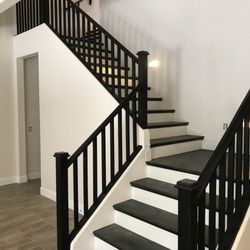 Chek-Homes - Ceramic Tile Hardwood Stair Treads with White Risers and painted handrails