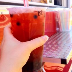 Raspberry black tea with boba.