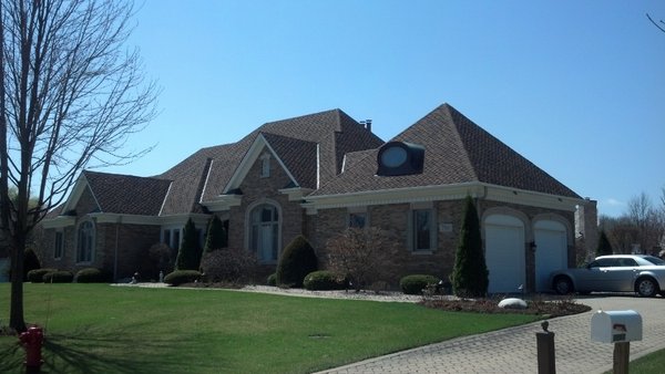 New Roof - The objective of this project was to replace the aged cedar shake roof with a more durable, low-maintenance roofing system while maintaining the aesthetic charm of the original design. The new CertainTeed Presidential Shake TL shingles were selected for their superior performance, triple-layer construction, and authentic wood shake appearance, breathing new life into the home’s exterior.

Scope of Work:

Initial Inspection: Conducted a thorough evaluation of the existing cedar shake roof, identifying areas of wear and structural concerns.

Removal: Carefully removed the old cedar shake roofing, ensuring proper disposal and maintaining site cleanliness.

Structural Preparation: Inspected and repaired the roof decking to create a solid foundation for the new installation.

Underlayment Installation: Installed a high-performance underlayment to enhance moisture resistance and roof longevity.

Shingle Installation: Installed CertainTeed Presidential Shake TL shingles, known for their dimensional appearance, weather resistance, and Class A fire rating.

Ensured all flashing, vents, and ridge caps were securely sealed to prevent leaks and optimize ventilation.

The new roofing system not only restored the home’s curb appeal but also provided long-lasting protection against the elements. The rich texture and multi-dimensional design of the CertainTeed Presidential Shake TL shingles closely mimic natural wood shakes, enhancing the property's aesthetic while offering superior durability and low maintenance. The client expressed satisfaction with the quality craftsmanship, efficient timeline, and overall transformation of their home.

For expert roof replacement services, contact Presidential Roofing Inc. at (847) 581-1040 and let us help you bring your home back to life.