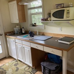 Lopez Farm Cottages and Tent Camping - Kitchenette- microwave, mini fridge, hot plate and pan are included. A few dishes, silverware, Salt pepper tea and coffee are here.