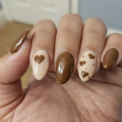 Pro-File Nails and Spa - Brown and nude nails with heart accents.