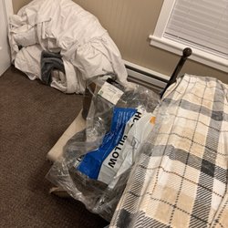 Track 89 - Entire bedding in a pile in the corner with wrappers from our sheets/pillows/ blanket from wal mart.