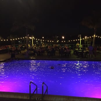 Sunset Grille & Raw Bar - Overlooking the lit pool from the bar area. - Seafood Near Me - Marathon, Florida Sunset Grille & Raw Bar - Overlooking the lit pool from the bar area. - Seafood Near Me - Marathon, Florida