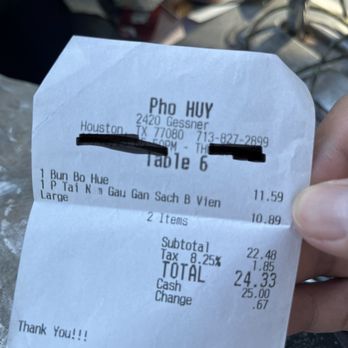 Pho Huy - a person holding a receipt - Vietnamese Near Me - Houston, Texas