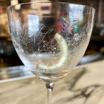 NOLA Seafood & Spirits - A closeup of the intricately-etched Nick & Nora Gimlet coupe. - Seafood Near Me - Baltimore, Maryland NOLA Seafood & Spirits - A closeup of the intricately-etched Nick & Nora Gimlet coupe. - Seafood Near Me - Baltimore, Maryland