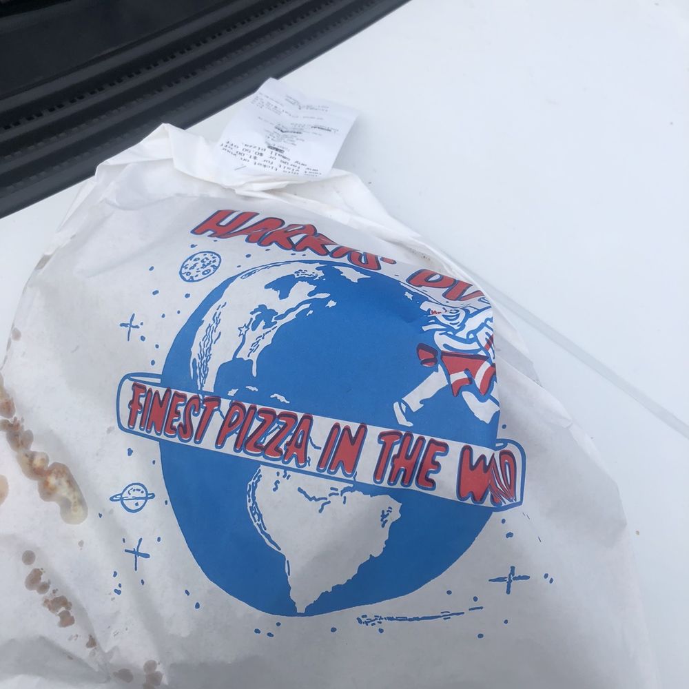 Pizza to go on a cardboard disk , then in a bag. Haven't seen this before Pizza to go on a cardboard disk , then in a bag. Haven't seen this before