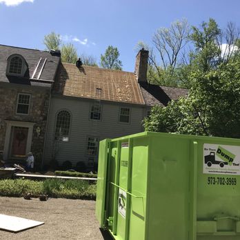 Father and Sons Home Improvements - a green dumpster in front of a house - Roofing Near Me - Paramus, New Jersey