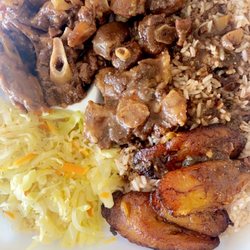 Oxtail with rice beans, cabbage, and fried plantains