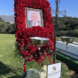 The flower and picture arrangement which was part of the Monarch's funeral service package. The flower and picture arrangement which was part of the Monarch's funeral service package.