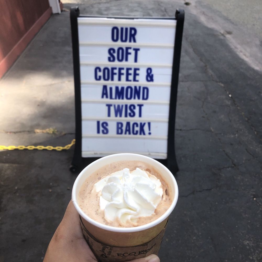 a hand holding a cup of coffee a hand holding a cup of coffee