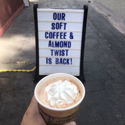 a hand holding a cup of coffee a hand holding a cup of coffee