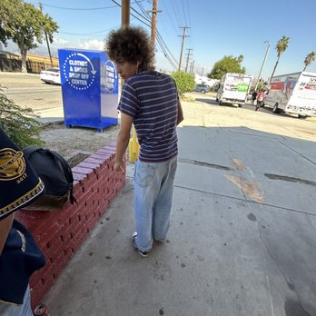 Alta Dena Dairy - a man walking down a sidewalk - Convenience Stores Near Me - San Bernardino, California