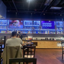 Dae Jang Keum - One side of wall with TV and many different liquors