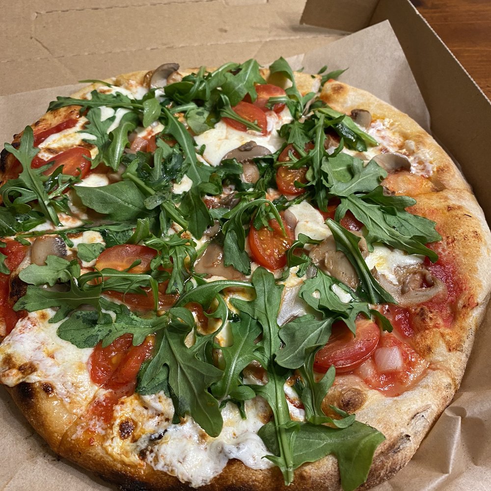 Presti Pizza - Veggie pizza - arugula is placed after coming out of the oven. - Food Trucks Near Me Presti Pizza - Veggie pizza - arugula is placed after coming out of the oven. - Food Trucks Near Me