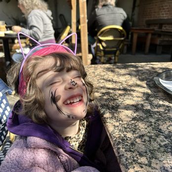Café Leila - Happy toddler in the back garden - New American Near Me - Berkeley, California