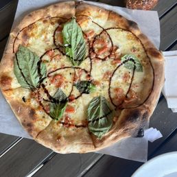 Bianco Bruschetta pizza. Usually a square pizza but they ran out of that dough