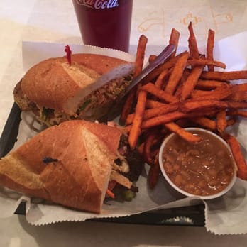 Satchmo's - Blackened Catfish Po' Boy with sweet potato fries and smoked baked beans. - Cajun/Creole Near Me - Flagstaff, Arizona