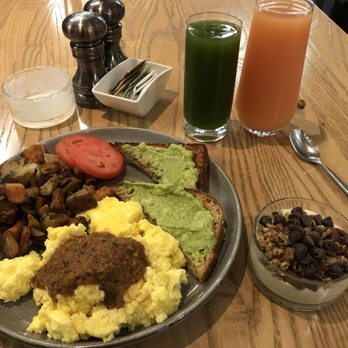 Former Saint Craft Kitchen and Taps - Scrambled eggs, mixed country potatoes, sliced tomatoes, avocado toast, and a peach smoothie bowl. - Bars Near Me - Denver, Colorado Former Saint Craft Kitchen and Taps - Scrambled eggs, mixed country potatoes, sliced tomatoes, avocado toast, and a peach smoothie bowl. - Bars Near Me - Denver, Colorado