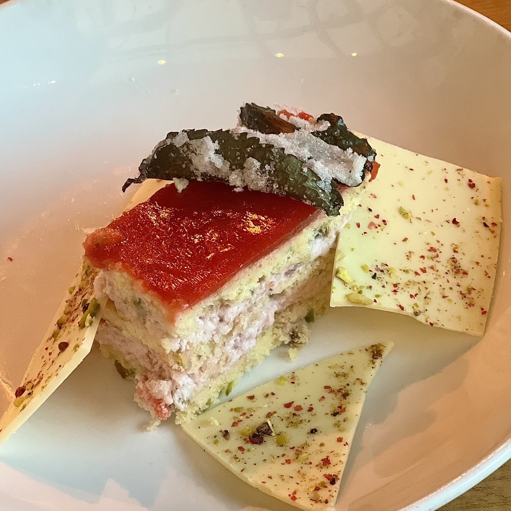 Tinker Street - Strawberry Dacquoise - Strawberry Mousse and glaze, Pistachio Cake,, White Chocolate Bark with Pistachio & Pink Peppercorn, Frosted Mint - Wine Bars Near Me - Indianapolis, Indiana Tinker Street - Strawberry Dacquoise - Strawberry Mousse and glaze, Pistachio Cake,, White Chocolate Bark with Pistachio & Pink Peppercorn, Frosted Mint - Wine Bars Near Me - Indianapolis, Indiana