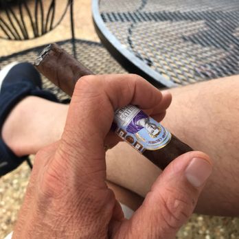Carolina Cigars - a hand holding a cigar - Cigar Bars Near Me - Hilton Head Island, South Carolina Carolina Cigars - a hand holding a cigar - Cigar Bars Near Me - Hilton Head Island, South Carolina