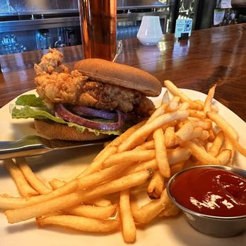 Sedona Taphouse - Crispy Chicken Sandwich Crispy chicken breast** coated in a hot honey glaze, romaine, pickles, ranch, on a gluten free bun with fries. - New American Near Me - Nashville, Tennessee