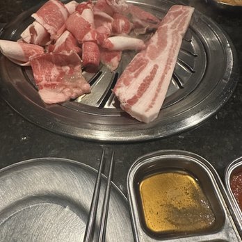 Iron Age Glenview - Server put the pork belly and brisket down on the grill for us at the same time... - Barbeque Near Me - Glenview, Illinois