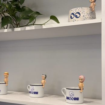 Snooze Cafe - inside they have a shelf display with mugs and merch for purchase - Coffee & Tea Near Me - Seattle, Washington