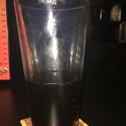 a drink in a glass on a coaster a drink in a glass on a coaster