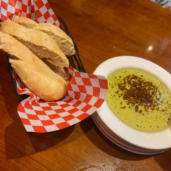 Johnny Carino's - Bread with olive oil and roasted garlic - Italian Near Me - Downey, California Johnny Carino's - Bread with olive oil and roasted garlic - Italian Near Me - Downey, California