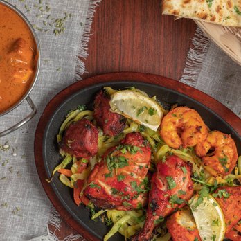 New Kathmandu Kitchen - a pan of chicken tikka masala with a side of naan bread - Himalayan/Nepalese Near Me - Sacramento, California New Kathmandu Kitchen - a pan of chicken tikka masala with a side of naan bread - Himalayan/Nepalese Near Me - Sacramento, California