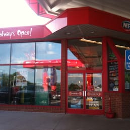 a woman's awning open sign in front of a store