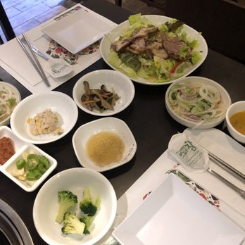 Bi Won - large assortment of appetizers--tuna salad, pig's feet on top of assorted salad with some horseradish. - Korean Near Me - Oakland Gardens, New York