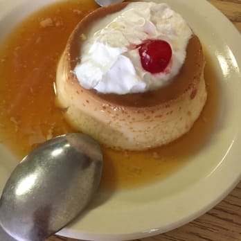 Mi Tierra - a plate of flan flan with a cherry on top - Mexican Near Me - Hoisington, Kansas