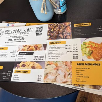 UpStream Cafe - a menu and a drink on a table - Caribbean Near Me - Poughkeepsie, New York